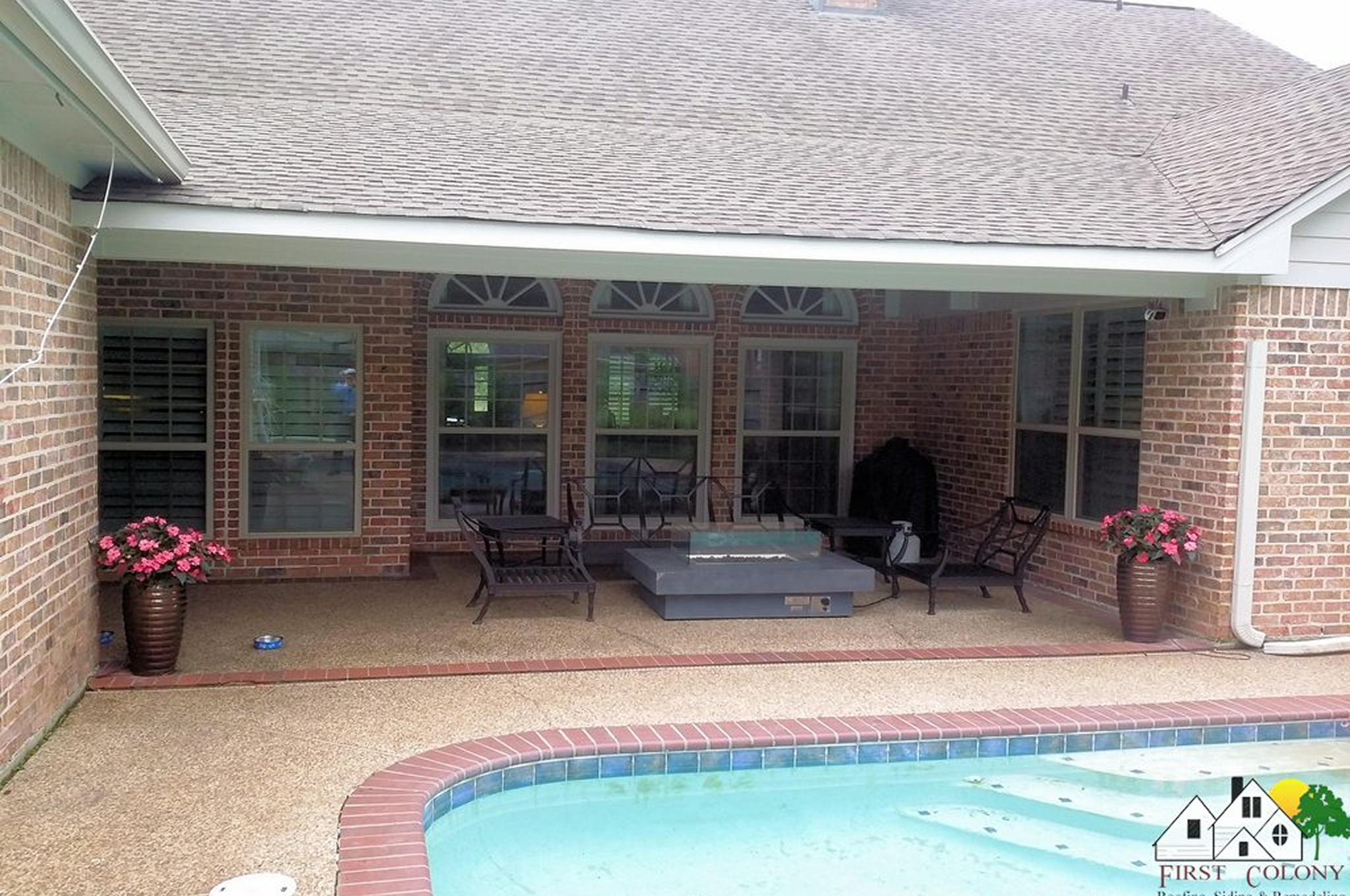 Backyard patio with a hot tub and pool under a covered porch.