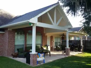 Cozy backyard patio with cushioned seating and a covered porch.