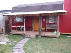 Cozy wooden cabin with a porch and garden path.
