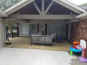 Covered patio with seating and decorative elements.