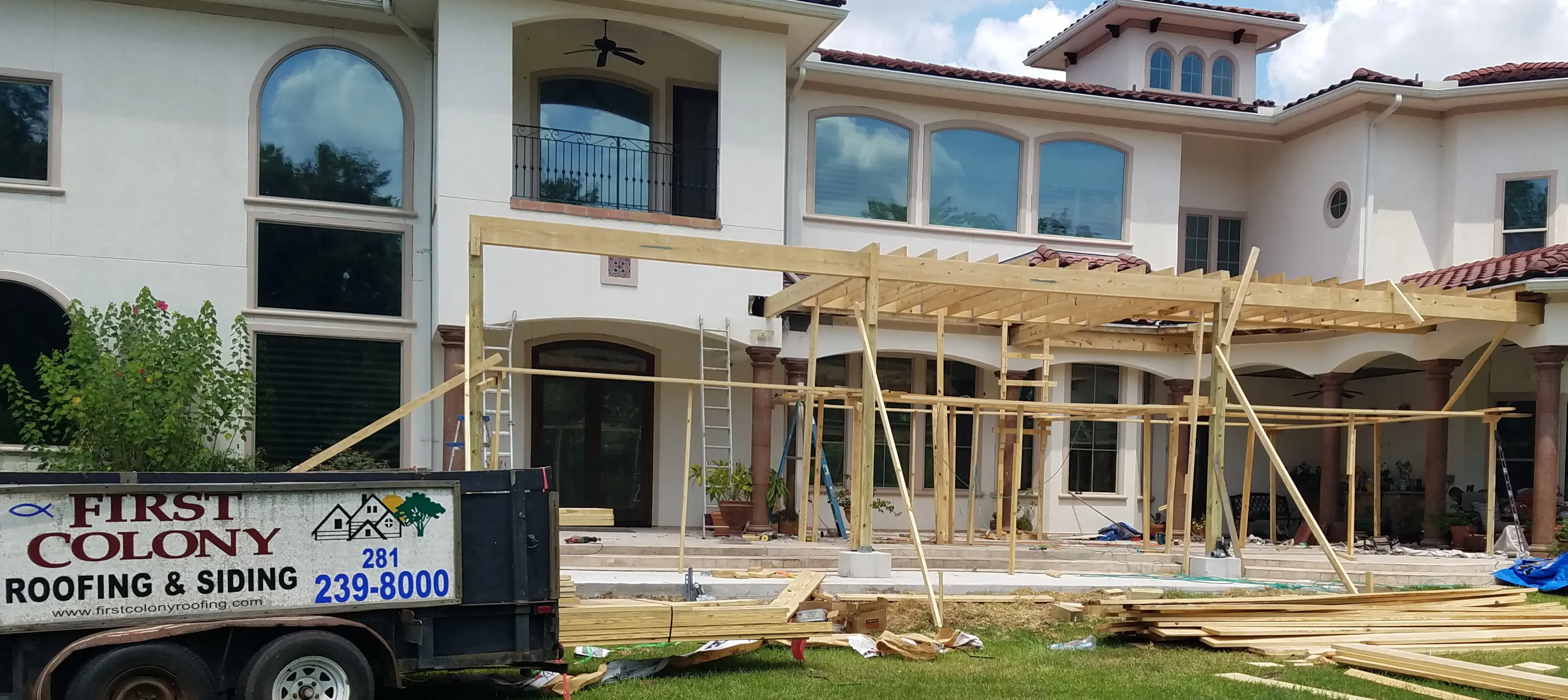 House under construction with wooden scaffolding outside.