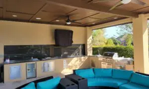 Outdoor lounge area with blue curved sofas and scenic view.