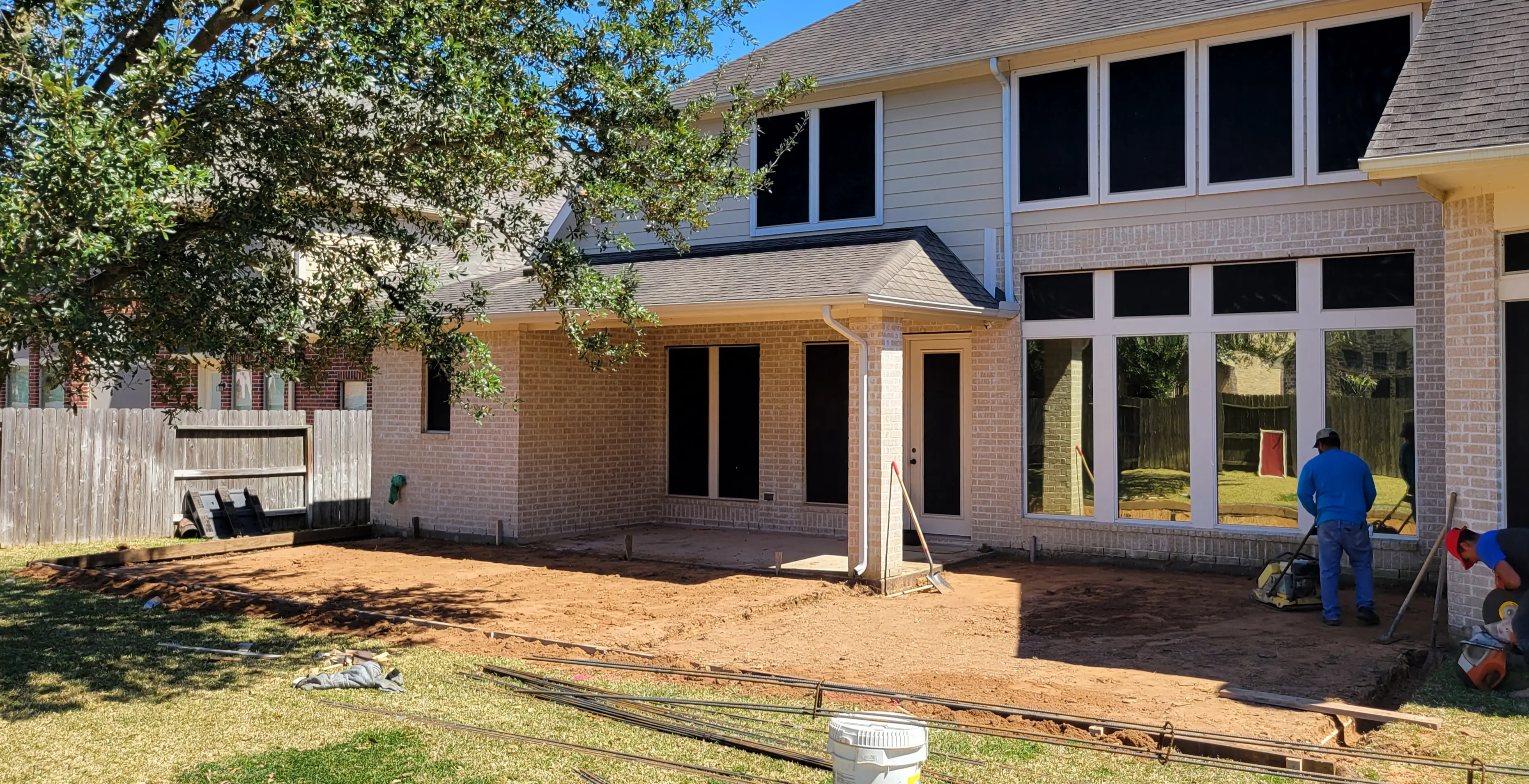 A partially constructed house with exposed windows and a covered porch.