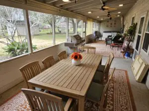 Cozy indoor dining area with wooden furniture and garden views.