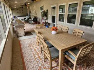 Cozy outdoor dining area with a wooden table and chairs.
