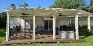 Cozy porch with chairs and a wooden deck under a pergola.