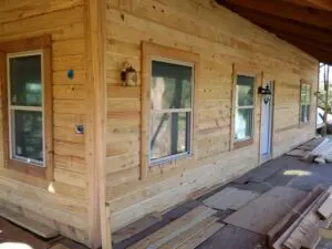 Wood-planked house exterior with windows