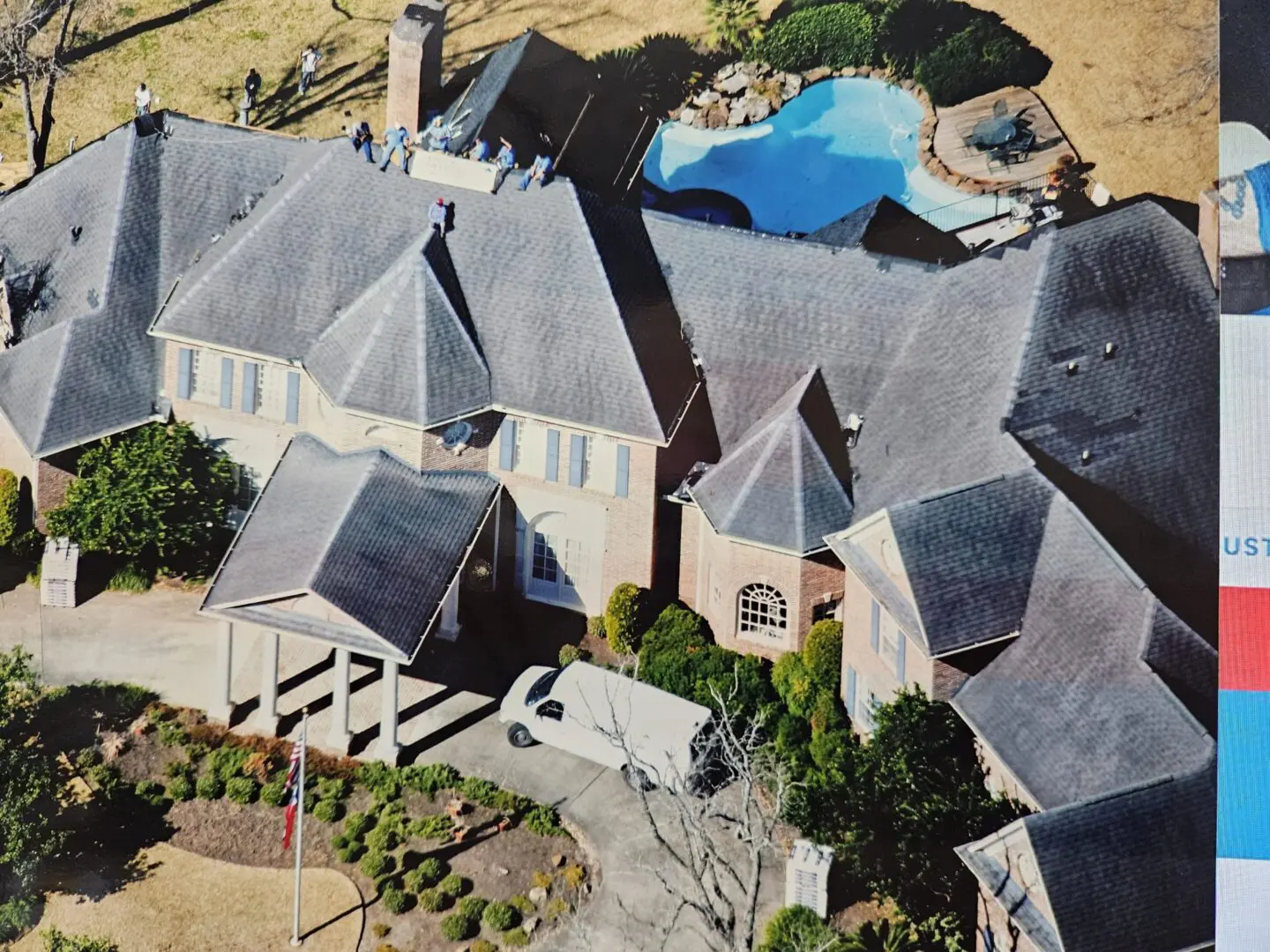 Aerial view of house with workers and pool