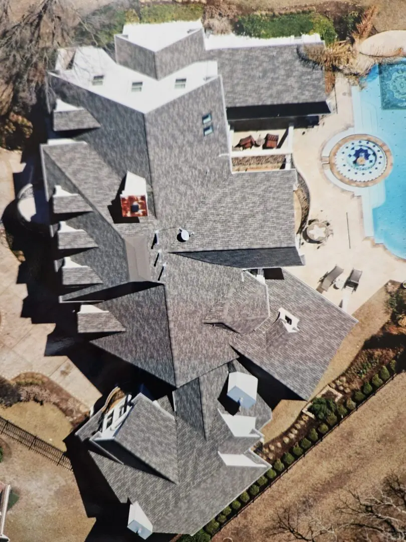 Aerial view of house rooftop and pool